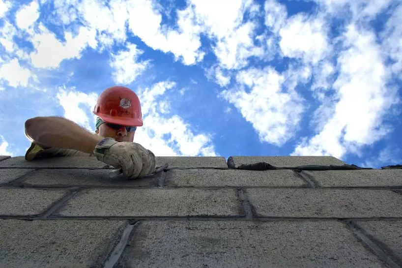 man working sky roof wall asphalt